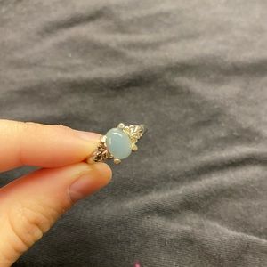 silver ring with light blue gem